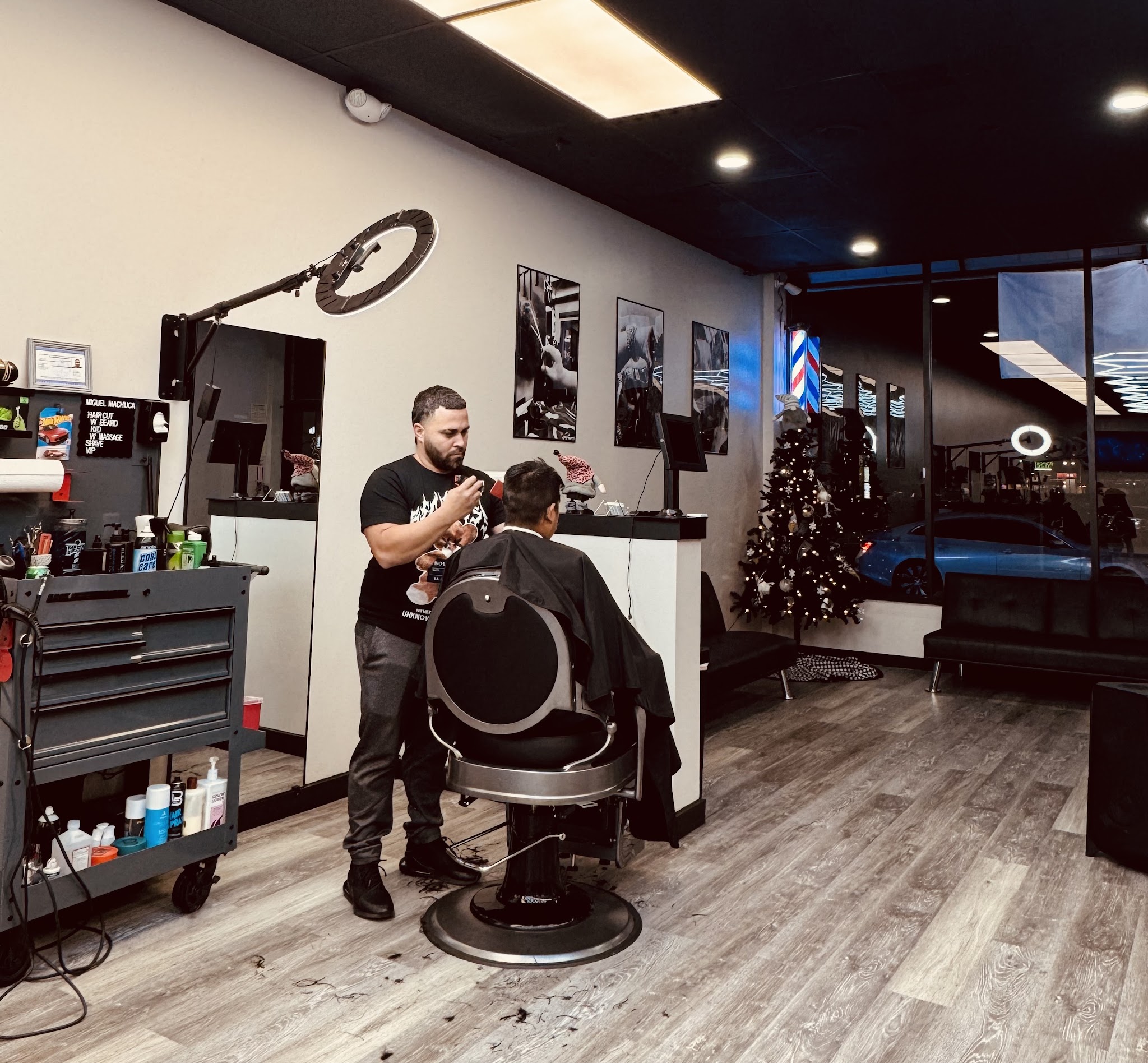 A barber cutting at his station